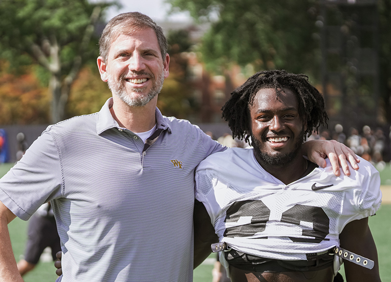 Dr. Hubbard with a Wake Forest football player on the sideline